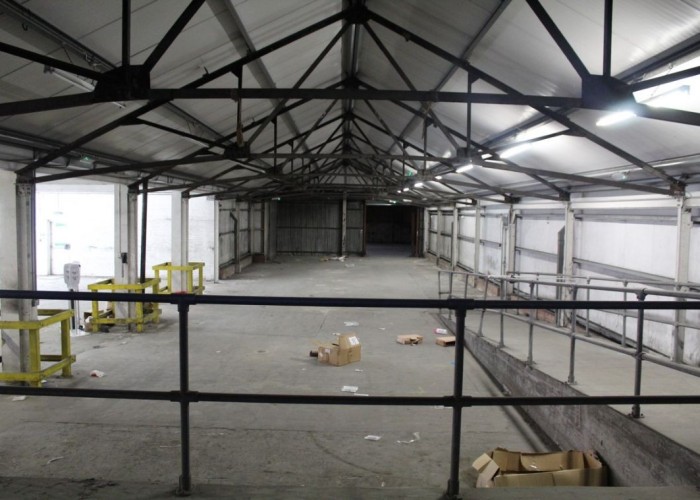 19. Dark warehouse with ramp and concrete pillars for filming